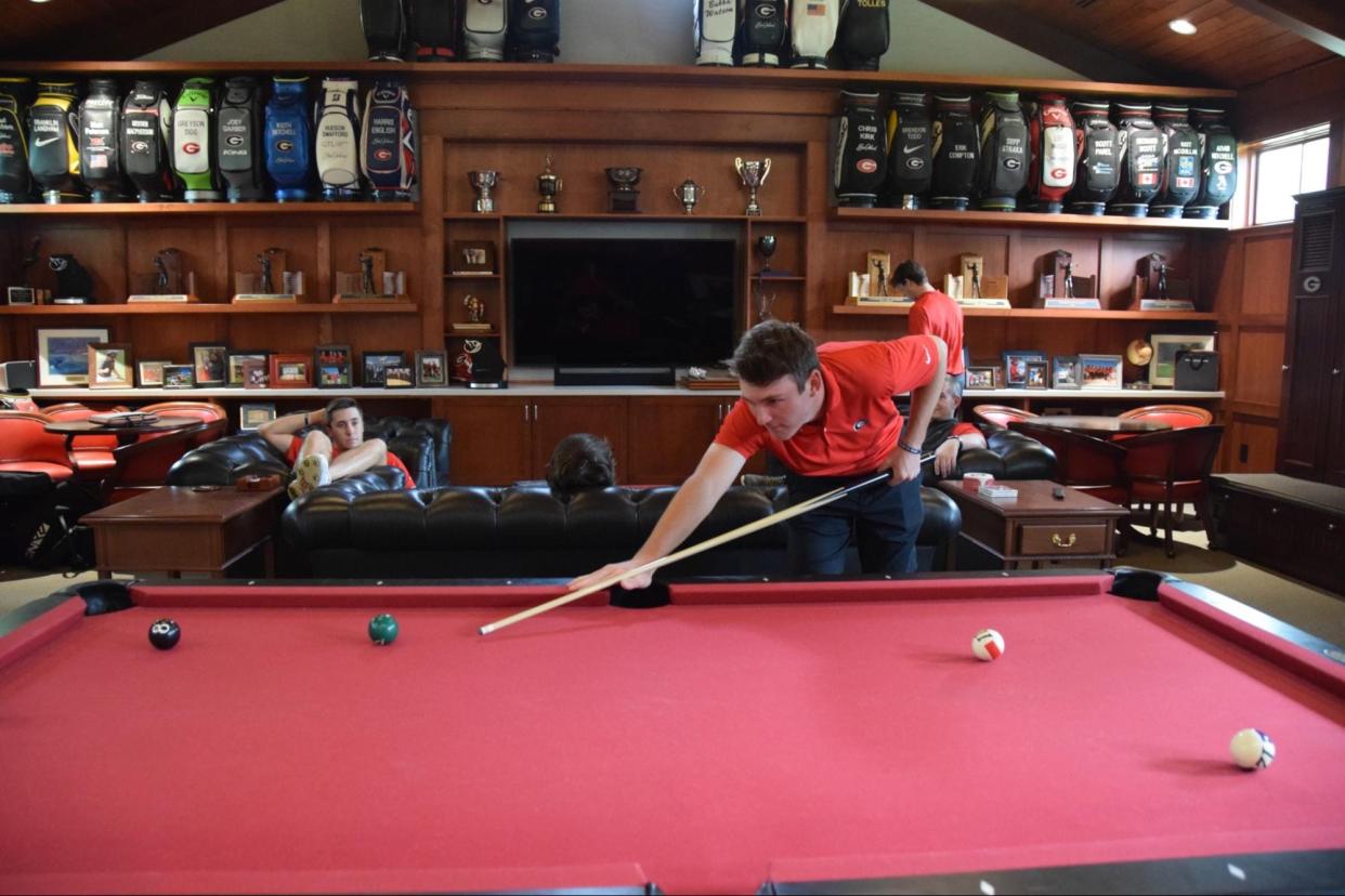 UGA golfer Trent Phillips shoots pool with teammate Ben van Wyk in the Boyd Golf Center on April 11. Head coach Chris Haack moved the billiards table to the locker room from his house this season.