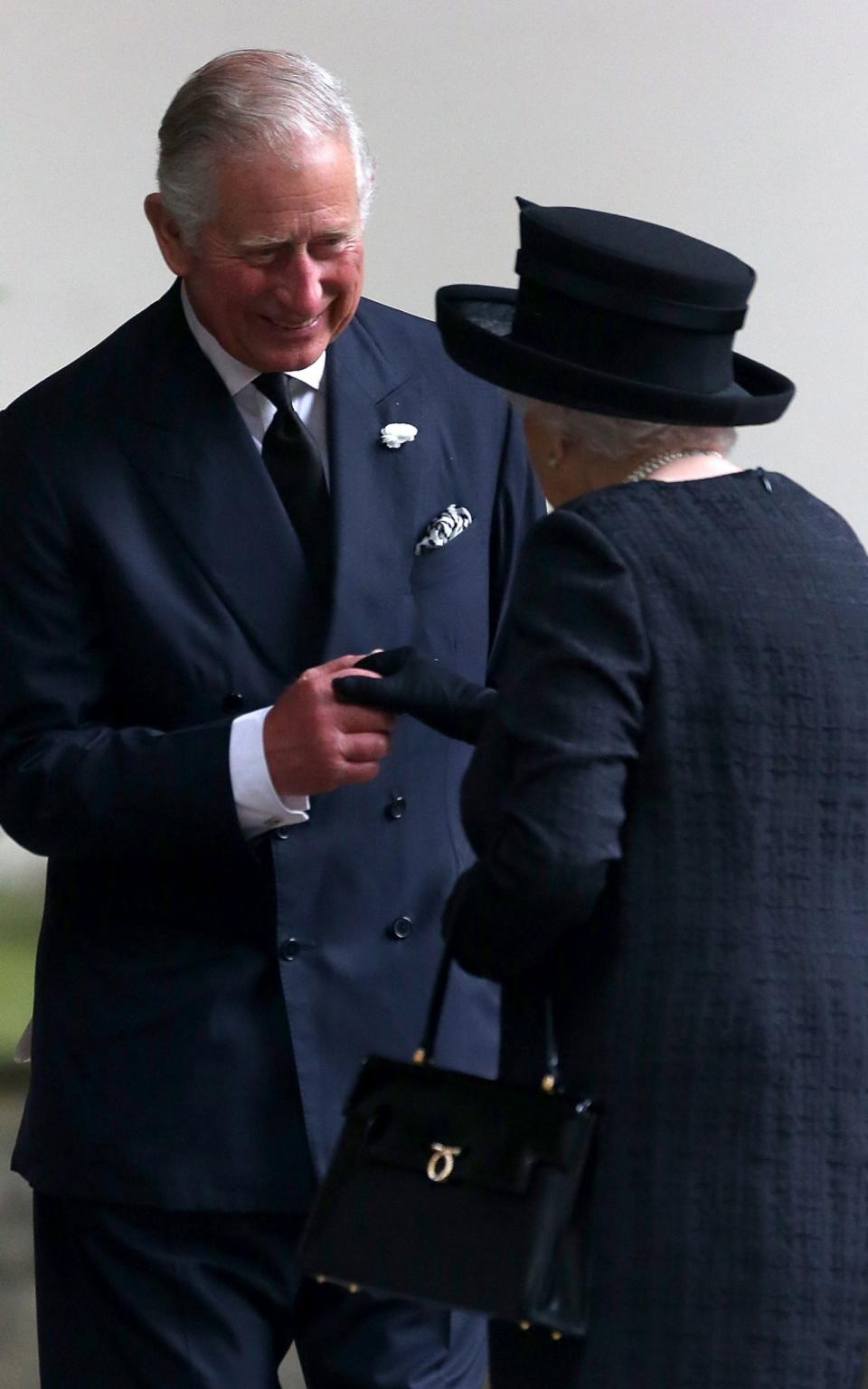 Charles, Prince of Wales, comforts the Queen - Credit: DMC/GC Images