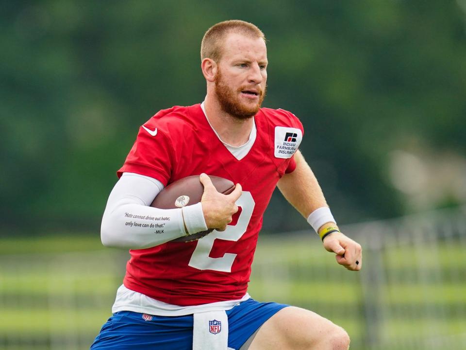 Carson Wentz runs with the ball at a Colts practice.