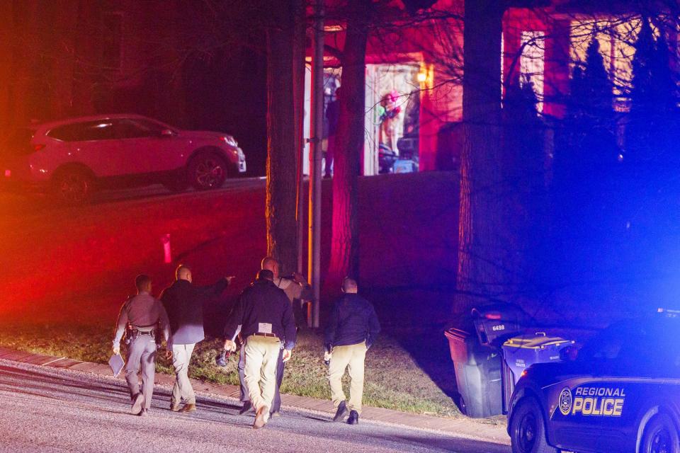 An officer gestures towards a treeline while police investigate the scene of a shooting on the 6400 block of Pamadeva Road, Wednesday, April 5, 2023, in Heidelberg Township. The man was flown to York Hospital by a medical helicopter.