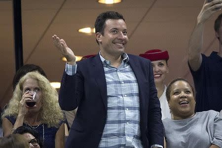 Television personality Jimmy Fallon dances as he attends the quarterfinals match between Roger Federer of Switzerland and Richard Gasquet of France at the U.S. Open Championships tennis tournament in New York, September 9, 2015. REUTERS/Carlo Allegri/Files