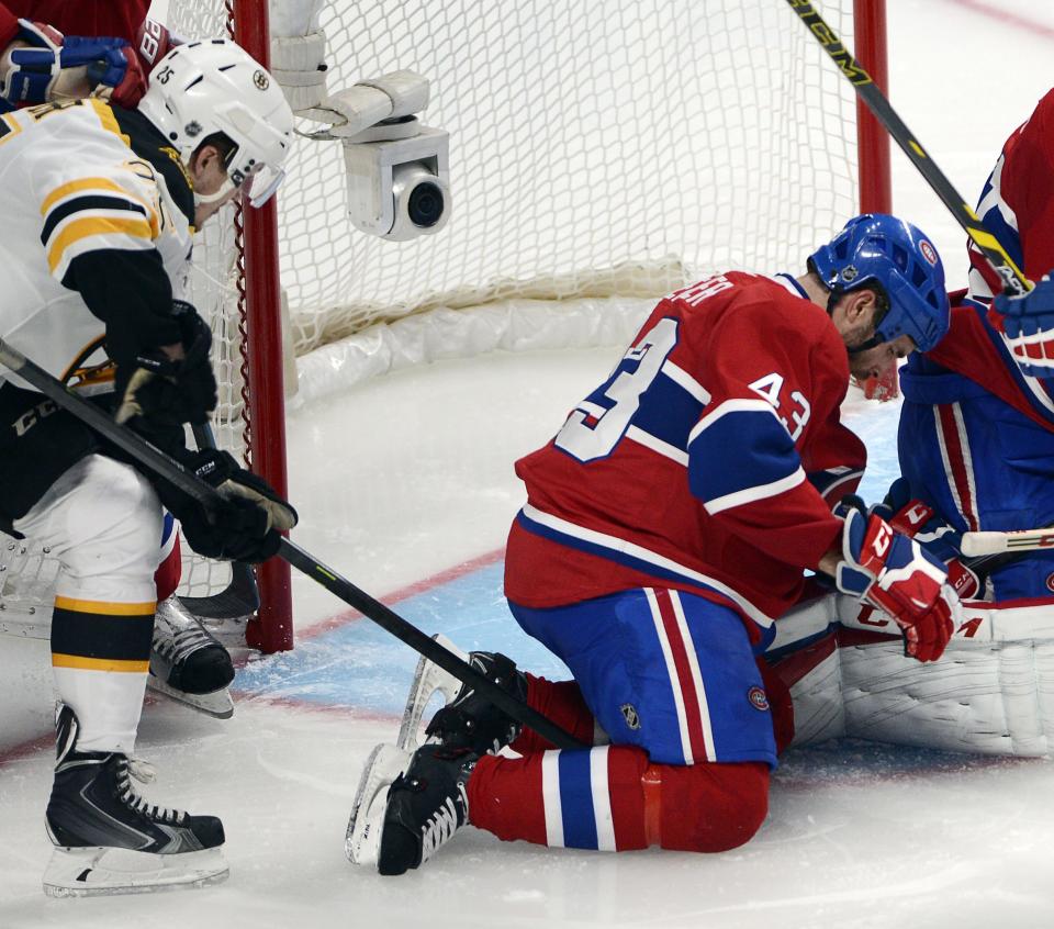 Boston Bruins Matt Fraser, left, pokes the puck past Montreal Canadiens defenseman Mike Weaver (43) to score the game-winning goal during the first overtime period in Game 4 in the second round of the NHL Stanley Cup playoffs Thursday, May 8, 2014, in Montreal. (AP Photo/The Canadian Press, Ryan Remiorz)