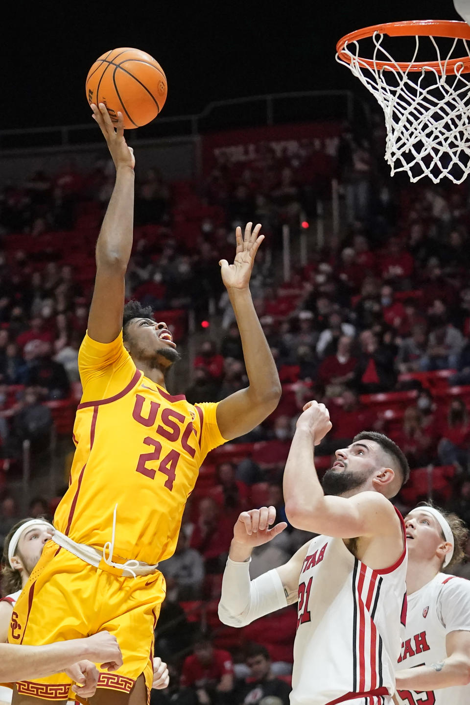 Southern California forward Joshua Morgan (24) shoots as Utah forward Dusan Mahorcic (21) defends in the first half during an NCAA college basketball game Saturday, Jan. 22, 2022, in Salt Lake City. (AP Photo/Rick Bowmer)