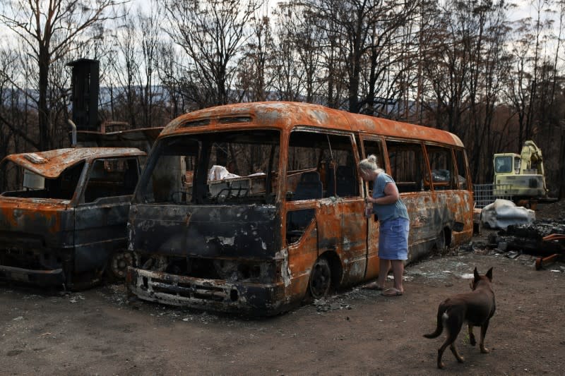 A resident returns to her property following the recent bushfires in Conjola Park