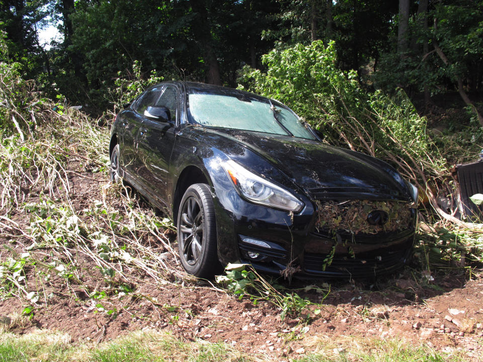 A car that was that was swept onto the banks of the Raritan River by the remnants of Tropical Storm Ida, remains in the area in Piscataway N.J, on Saturday, Sept. 4, 2021. (AP Photo/Wayne Parry)