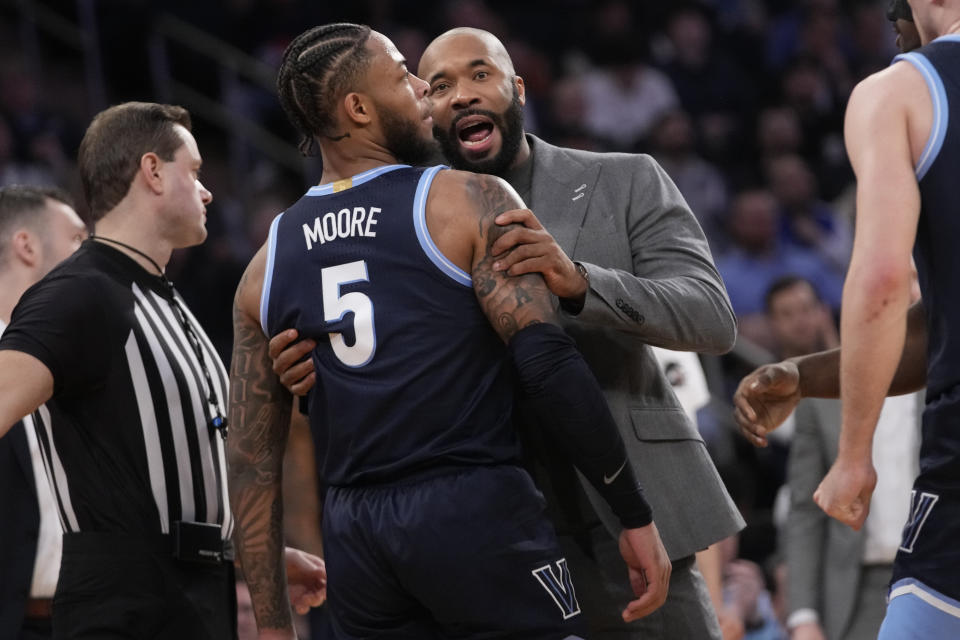 Villanova coach Kyle Neptune talks to guard Justin Moore (5) during the first half of the team's NCAA college basketball game against Marquette in the quarterfinals of the Big East men's tournament Thursday, March 14, 2024, in New York. (AP Photo/Mary Altaffer)