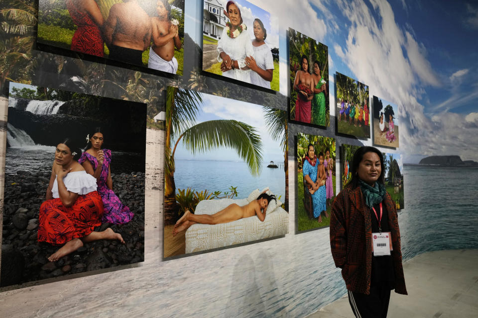 Artist Yuki Kihara poses next to installation "Paradise Camp" at New Zealand's pavilion during the 59th Biennale of Arts exhibition in Venice, Italy, Tuesday, April 19, 2022. (AP Photo/Antonio Calanni)