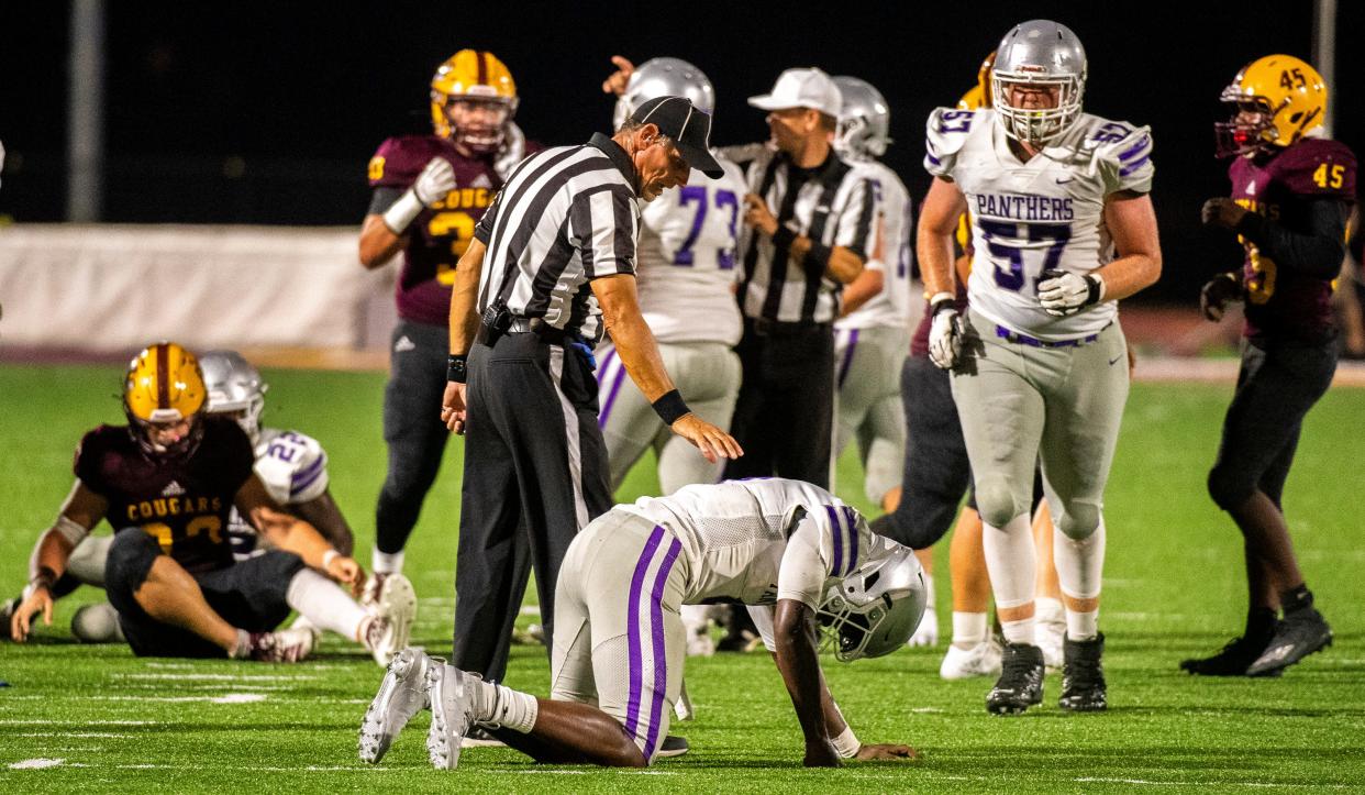 A referee checks on Bloomington South’s D.J. Bull (4) after a hard run during the Bloomington North versus Bloomington South football game Friday, September 11, 2020.