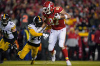 Kansas City Chiefs tight end Travis Kelce (87) tries to break a tackle by Pittsburgh Steelers cornerback Cameron Sutton (20) after catching a pass during the first half of an NFL wild-card playoff football game, Sunday, Jan. 16, 2022, in Kansas City, Mo. (AP Photo/Ed Zurga)