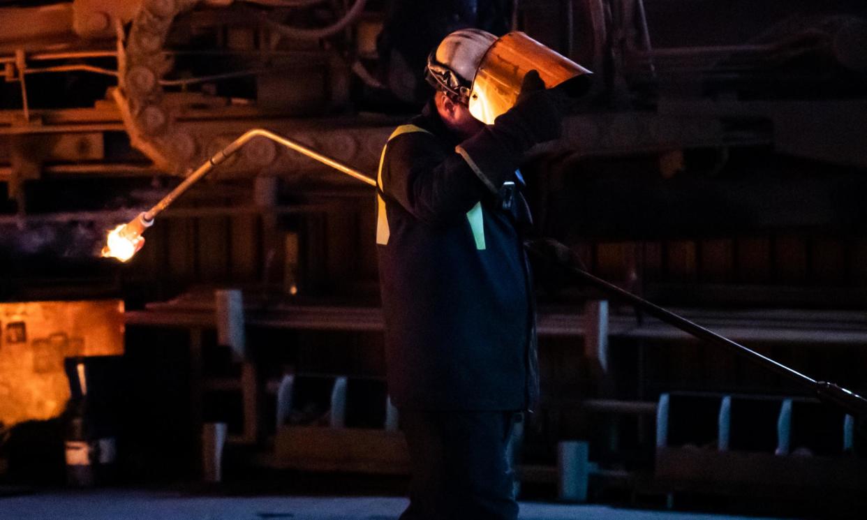 <span>A worker collects a sample from the blast furnace, Port Talbot, south Wales.</span><span>Photograph: Kara Thomas/Athena Pictures</span>