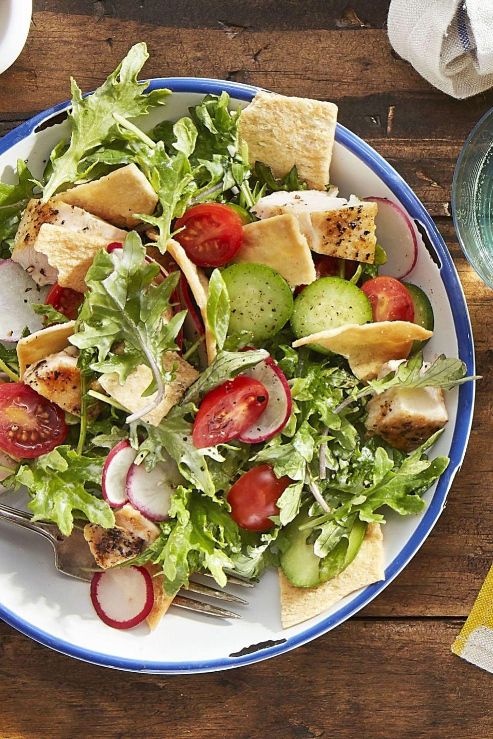<p>Cucumbers and radishes bring crunch <em>and </em>color to this baby kale salad.</p><p><strong><a href="https://www.countryliving.com/food-drinks/recipes/a44243/kale-chicken-pita-salad-recipe/" rel="nofollow noopener" target="_blank" data-ylk="slk:Get the recipe for Chicken Pita Salad" class="link ">Get the recipe for Chicken Pita Salad</a>.</strong></p>