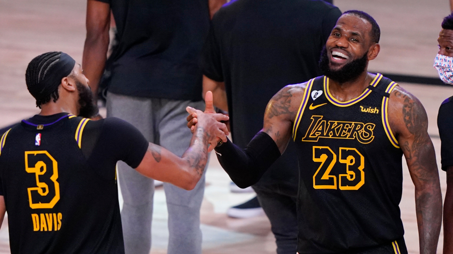 In this Sunday, Sept. 20, 2020, file photo, Los Angeles Lakers' LeBron James celebrates with teammate Anthony Davis after an NBA conference final playoff basketball game against the Denver Nuggets in Fla.
