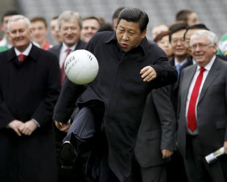 Then China's Vice-President Xi Jinping kicks a football during a visit to Croke Park in Dublin, Ireland, in this February 19, 2012 file photo. REUTERS/David Moir/Files