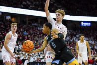 Marquette's Greg Elliott (5) shoots against Wisconsin's Steven Crowl (22) during the first half of an NCAA college basketball game Saturday, Dec. 4, 2021, in Madison, Wis. (AP Photo/Andy Manis)