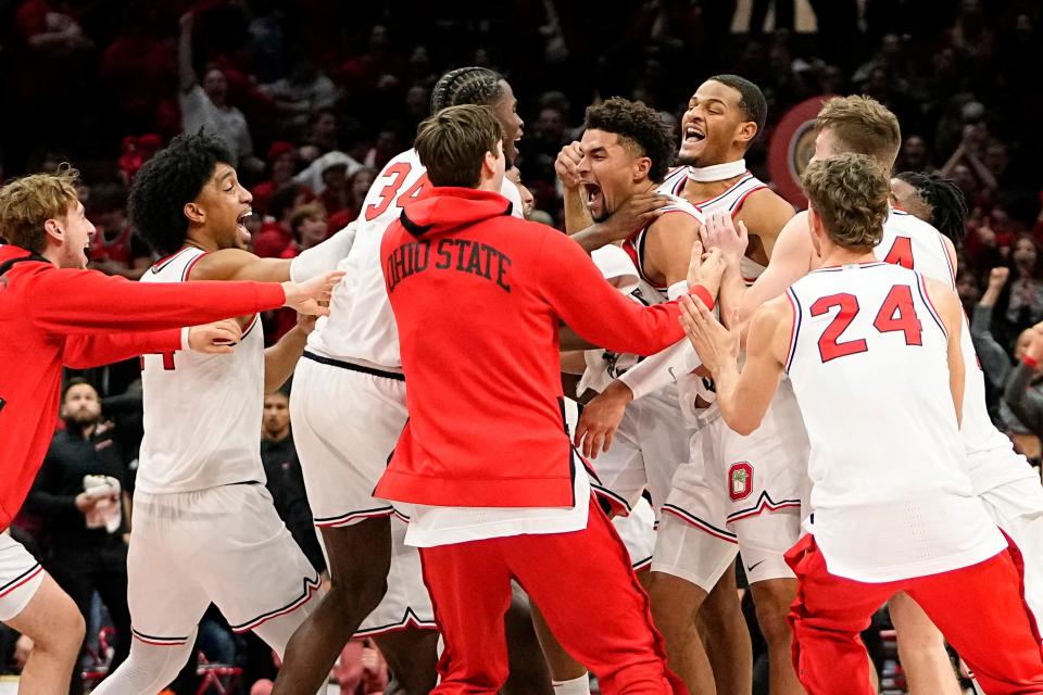 Dec 8, 2022; Columbus, OH, USA;  The Ohio State Buckeyes celebrate a buzzer beater by guard Tanner Holden (0) that gave them a 67-66 win over the Rutgers Scarlet Knights in the NCAA men's basketball game at Value City Arena. Mandatory Credit: Adam Cairns-The Columbus Dispatch