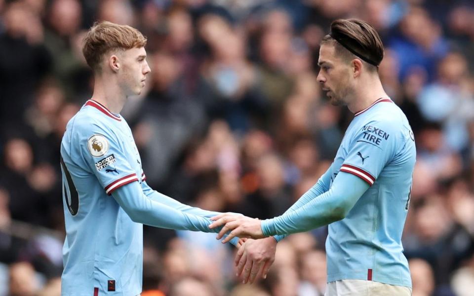 Cole Palmer replaces Jack Grealish of Manchester City during the Premier League match between Manchester City and Liverpool FC at Etihad Stadium on April 01, 2023 in Manchester, England