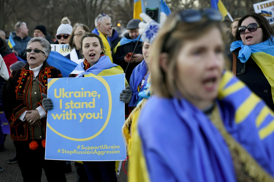 People gather following a vigil and march in solidarity with Ukraine outside the White House in Washington, Sunday, Feb. 20, 2022. (AP Photo/Patrick Semansky)