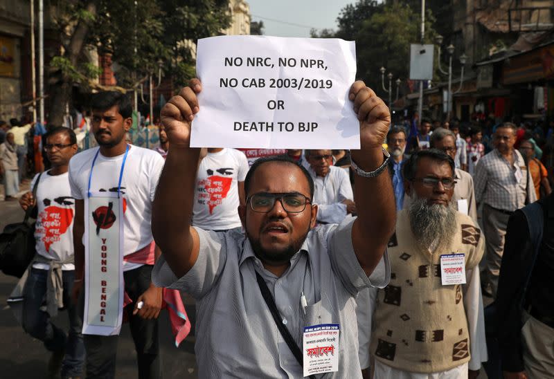 A demonstrator displays a placard during a protest against the Citizenship Amendment Bill, in Kolkata