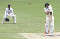 Australia's Steve Smith reacts as he hits the ball to be out caught during play on day four of the fourth cricket test between India and Australia at the Gabba, Brisbane, Australia, Monday, Jan. 18, 2021. (AP Photo/Tertius Pickard)