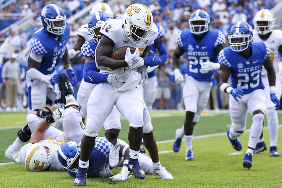 Chattanooga running back Ailym Ford (32) tries to break free from a tackle during the second half of a NCAA college football game against Kentucky in Lexington, Ky., Saturday, Sept. 18, 2021. (AP Photo/Michael Clubb)