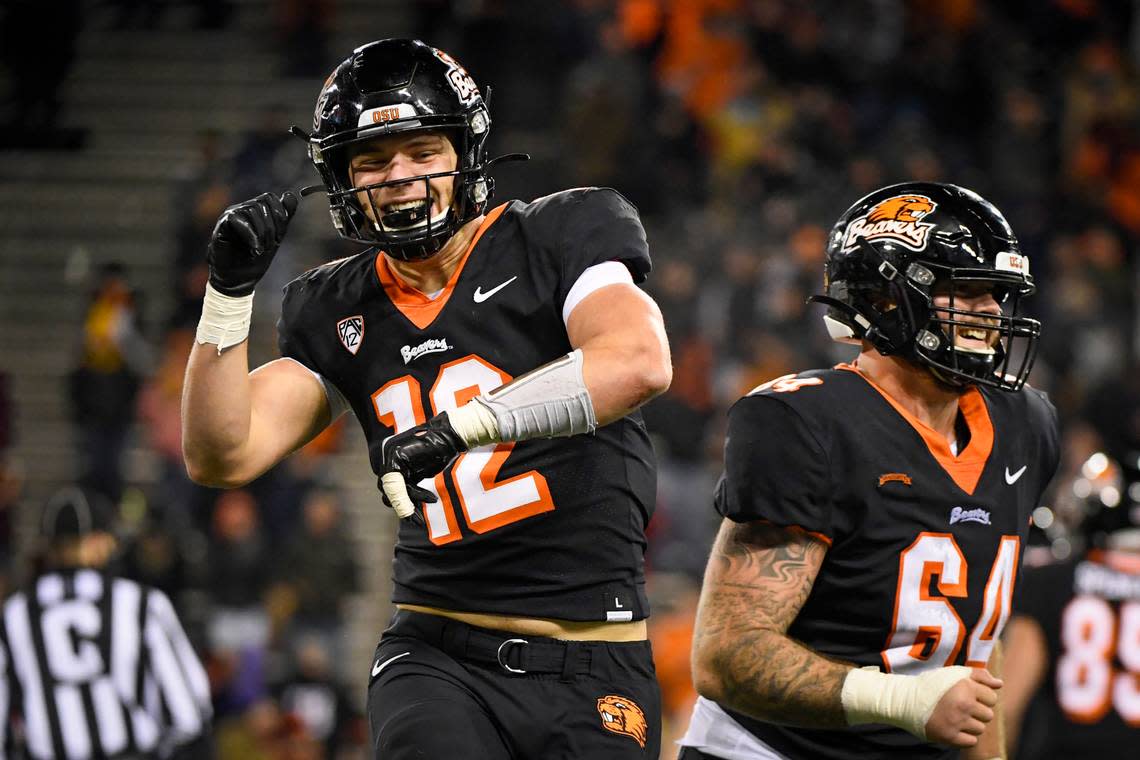 Oregon State linebacker Jack Colletto (12) and Oregon State offensive lineman Nathan Eldridge (64) celebrate Colleto’s touchdown in the fourth quarter of an NCAA college football game Saturday, Nov. 20, 2021, in Corvallis, Ore. (AP Photo/Andy Nelson)