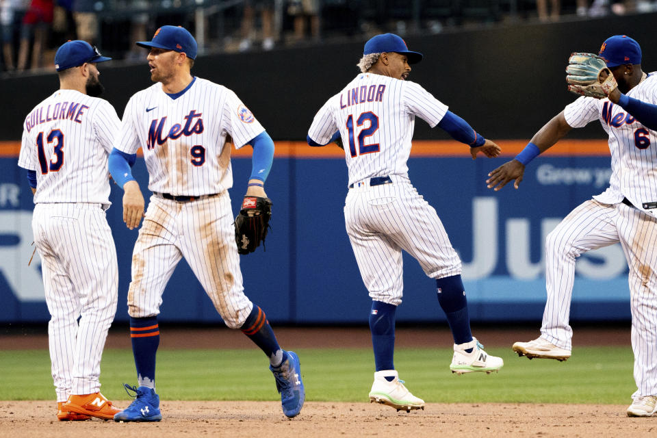 New York Mets' second baseman Luis Guillorme, center fielder Brandon Nimmo, shortstop Francisco Lindor and right fielder Starling Marte celebrate their win over the Atlanta Braves, Sunday, Aug. 7, 2022, in New York. (AP Photo/Julia Nikhinson)