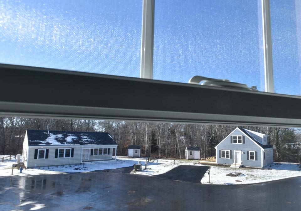 A second floor window offers a view of recently finished Habitat for Humanity homes on Murray Lane in West Harwich.