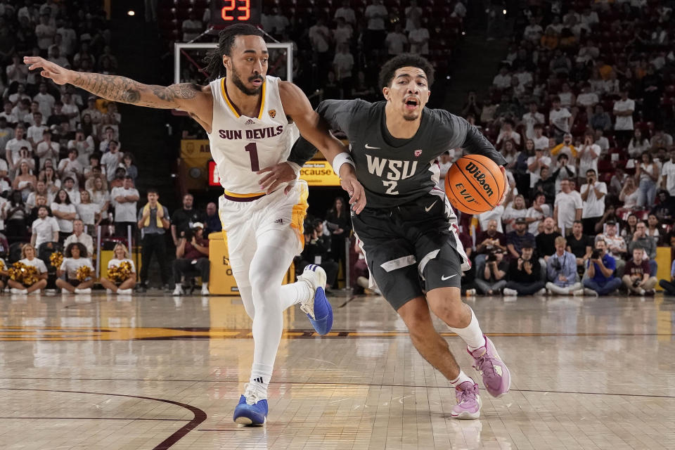 Washington State guard Myles Rice (2) struggles to get around Arizona State guard Frankie Collins (1) during the first half of an NCAA college basketball game Saturday, Feb. 24, 2024, in Tempe, Ariz. (AP Photo/Darryl Webb)