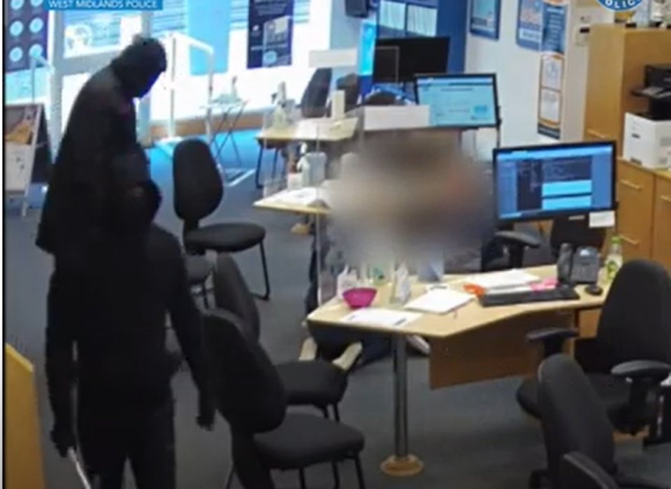 Staff members being forced onto the floor after the armed robbers burst into an estate agents (West Midlands Police)