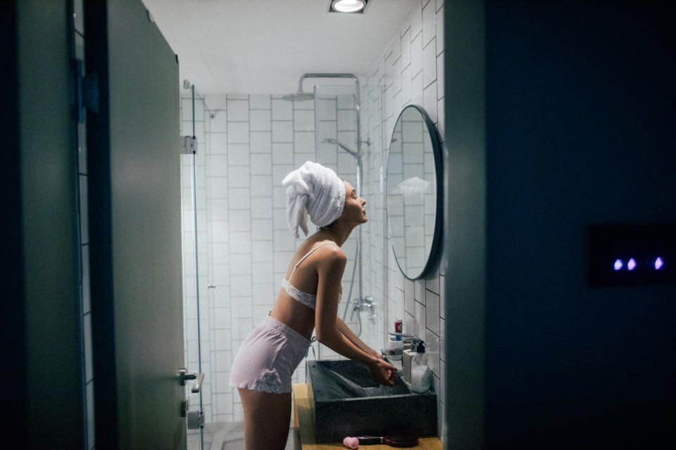 Stock picture of a woman just getting out of the shower at night. (Getty Images)