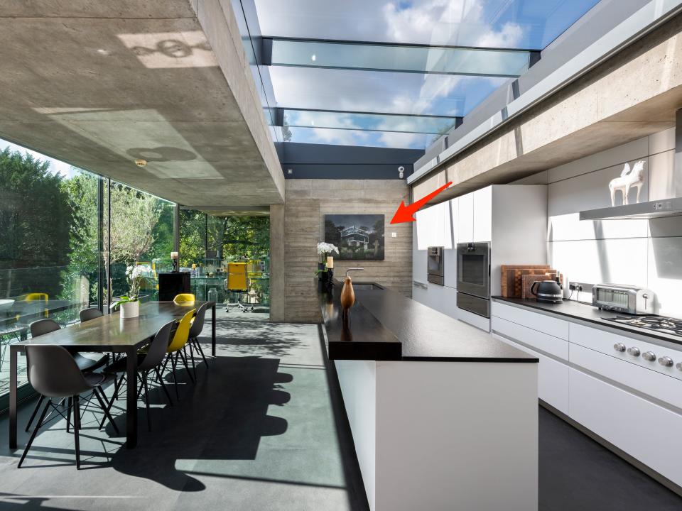 The sleek kitchen currently features a painting of the house surrounded by tombstones.