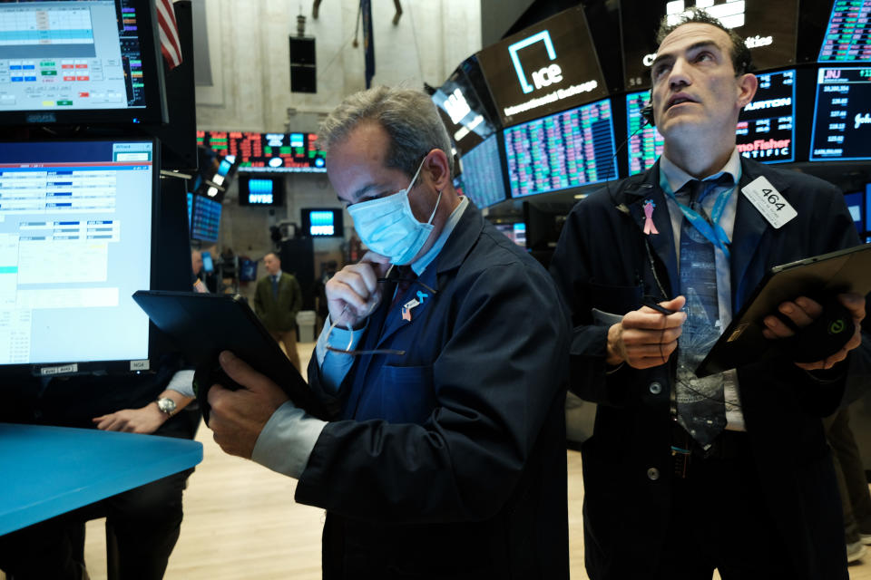 NEW YORK, NEW YORK - MARCH 20: Traders, some in medical masks, work on the floor of the New York Stock Exchange (NYSE) on March 20, 2020 in New York City. Trading on the floor will temporarily become fully electronic starting on Monday to protect employees from spreading the coronavirus. The Dow fell over 500 points on Friday as investors continue to show concerns over COVID-19.  (Photo by Spencer Platt/Getty Images)