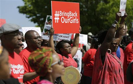 Protesters march in support of the girls kidnapped by members of Boko Haram in front of the Nigerian Embassy in Washington May 6, 2014. REUTERS/Gary Cameron