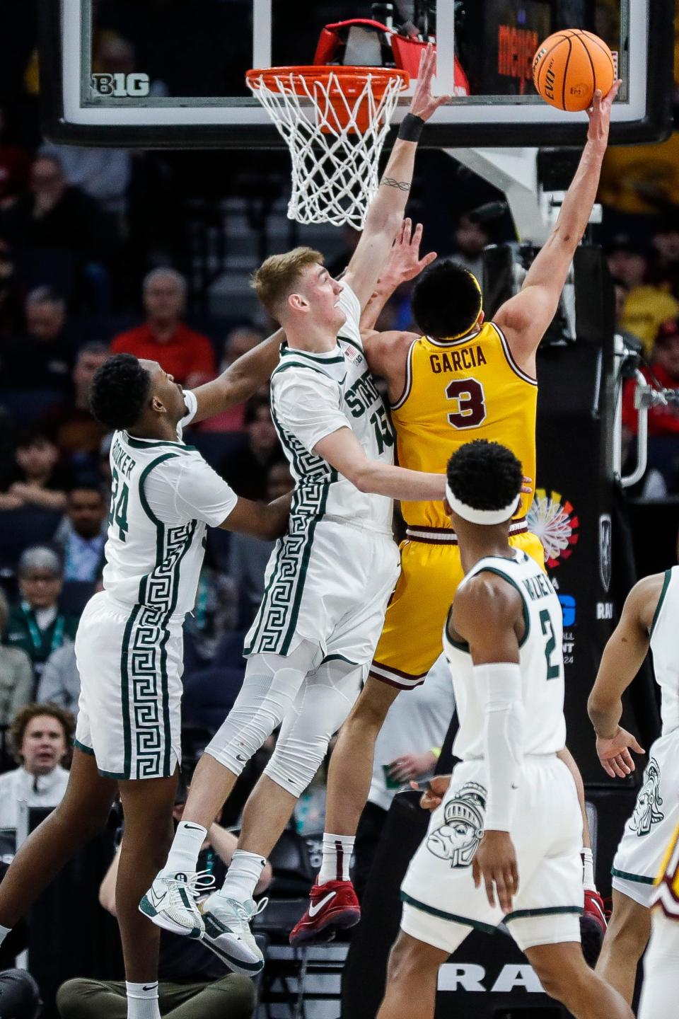 Michigan State center Carson Cooper (15) and forward Xavier Booker (34) defend =Minnesota forward Dawson Garcia (3) during the first half of Second Round of Big Ten tournament at Target Center in Minneapolis, Minn. on Thursday, March 14, 2024.