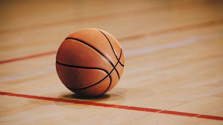 A basketball lies idle on the floor.