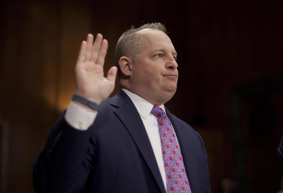 John J. Mulligan, executive Vice President and Chief Financial Office of the Target Corporation is sworn-in on Capitol Hill in Washington, Tuesday, Feb. 4, 2014, prior to testifying before the Senate Judiciary Committee hearing on data breaches and combating cybercrime. (AP Photo/Pablo Martinez Monsivais)