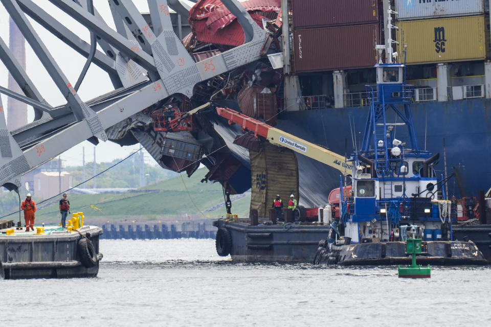 Workers remove wreckage of the collapsed Francis Scott Key Bridge, Thursday, April 25, 2024, in Baltimore. (AP Photo/Matt Rourke)