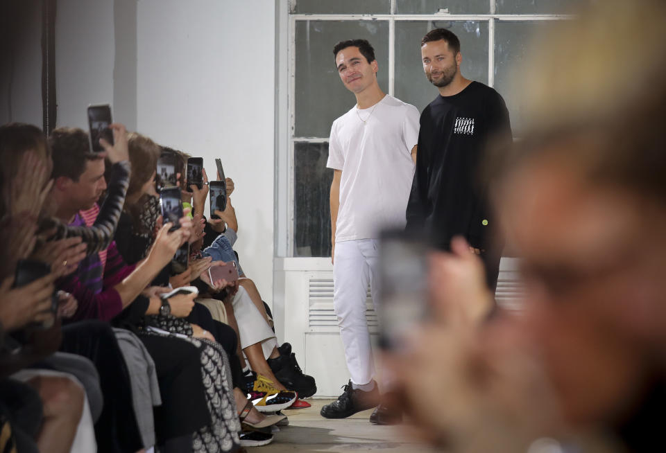 Fashion designers Lazaro Hernandez, left, and Jack McCollough, right, acknowledge applause after unveiling their latest collection for Proenza Schouler, during Fashion Week, Monday, Sept. 10, 2018 in New York. (AP Photo/Bebeto Matthews)