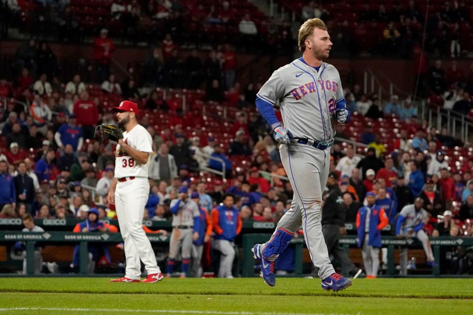 New York Mets' Pete Alonso, right, takes his base after being hit by a pitch from St. Louis Cardinals relief pitcher Kodi Whitley (38) during the eighth inning of a baseball game Tuesday, April 26, 2022, in St. Louis.