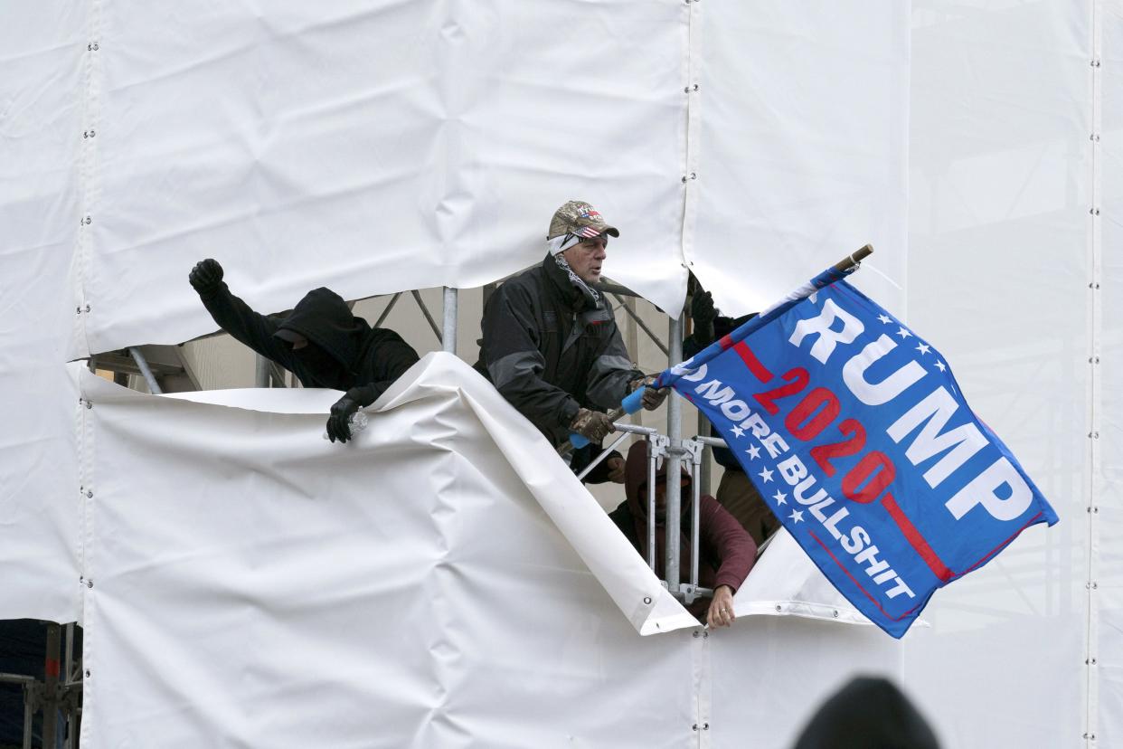 Trump supporters are seen outside the Capitol, Wednesday, Jan. 6, 2021, in Washington. As Congress prepares to affirm President-elect Joe Biden's victory, thousands of people have gathered to show their support for President Donald Trump and his claims of election fraud.