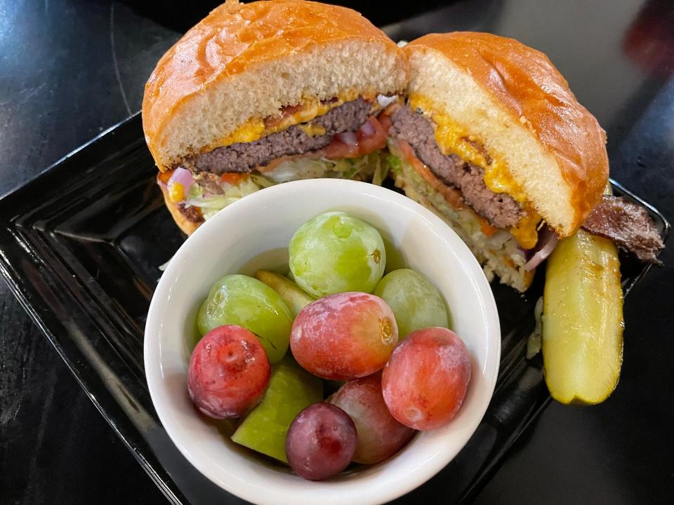Pimento cheese and bacon burger with fruit cup side from Brett's Casual American restaurant in Athens, Ga. on Monday, Nov. 20, 2023. Brett's has been in business since 2007.