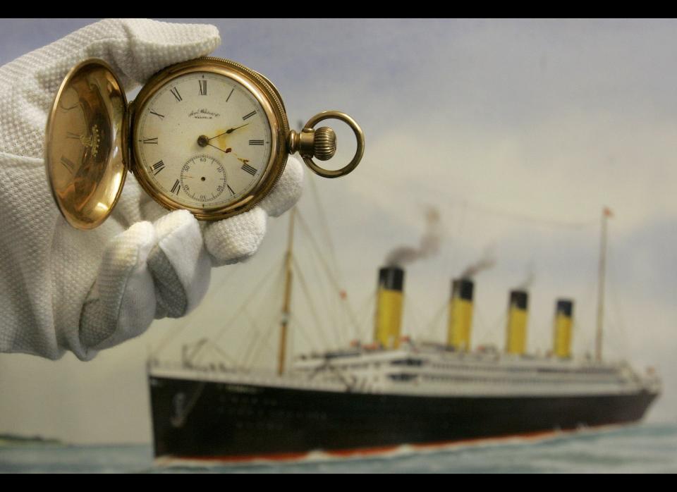 A gold plated Waltham American pocket watch, the property of Carl Asplund, is seen in front of a modern water colour painting of the Titanic by CJ Ashford at Henry Aldridge and Son auctioneers in Devizes, Wiltshire, England Thursday, April 3, 2008. 