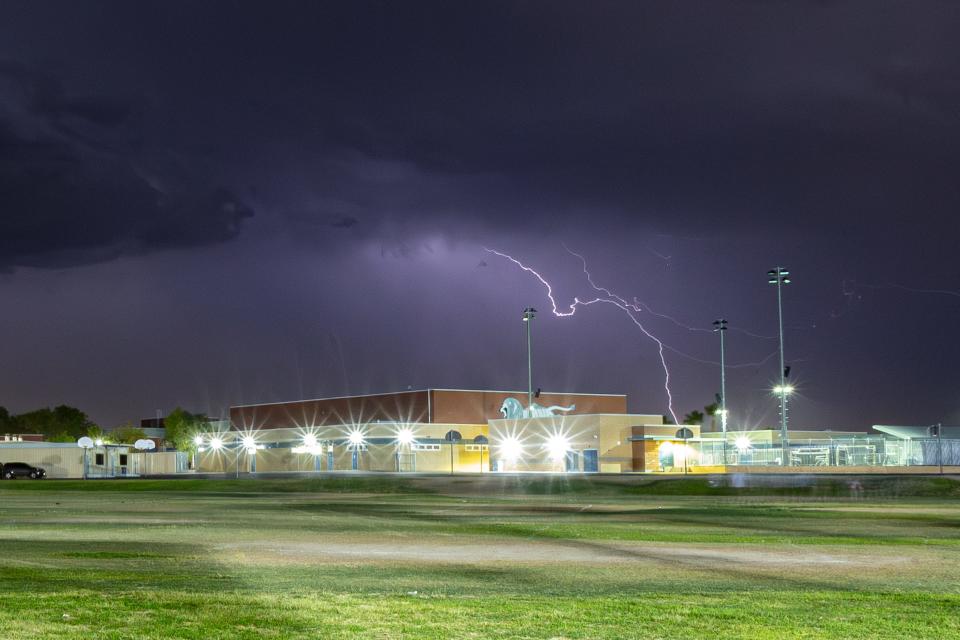 A lightning bolt strikes over Cathedral City High School on Aug. 18, 2023. A sudden thunderstorm halted the high school football game between Cathedral City and Indian Springs.