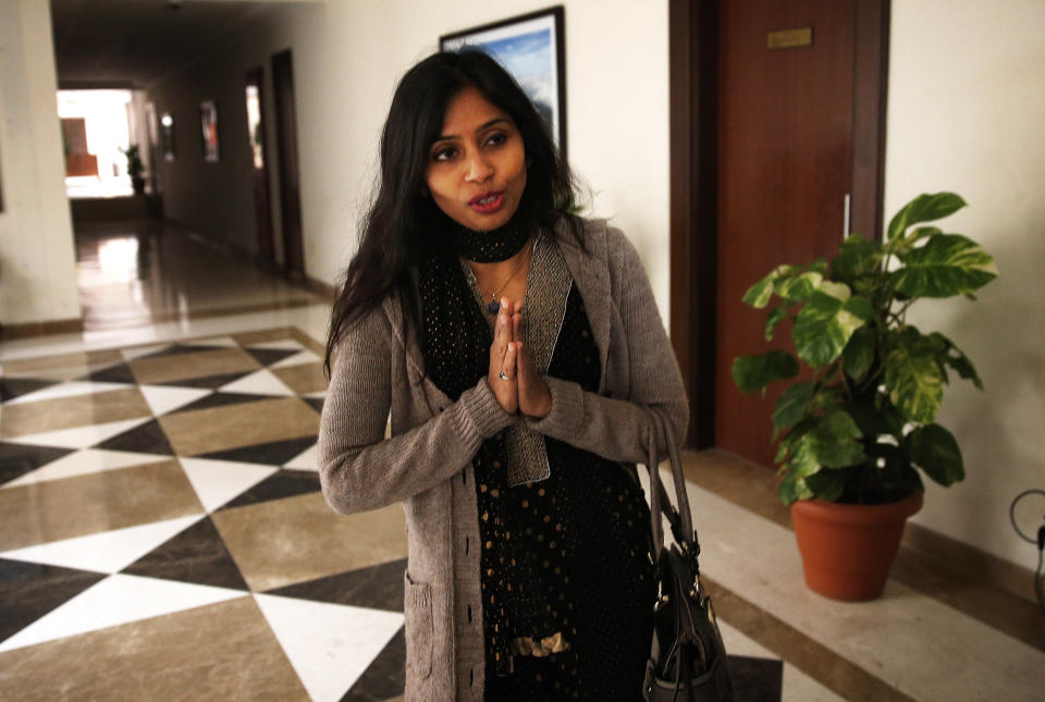 Devyani Khobragade, who served as India’s deputy consul general in New York, greets journalists as she leaves Maharastra state house in New Delhi, India, Saturday, Jan. 11, 2014. Khobragade, 39, is accused of exploiting her Indian-born housekeeper and nanny, allegedly having her work more than 100 hours a week for low pay and lying about it on a visa form. Khobragade has maintained her innocence, and Indian officials have described her treatment as barbaric. (AP Photo/Saurabh Das)