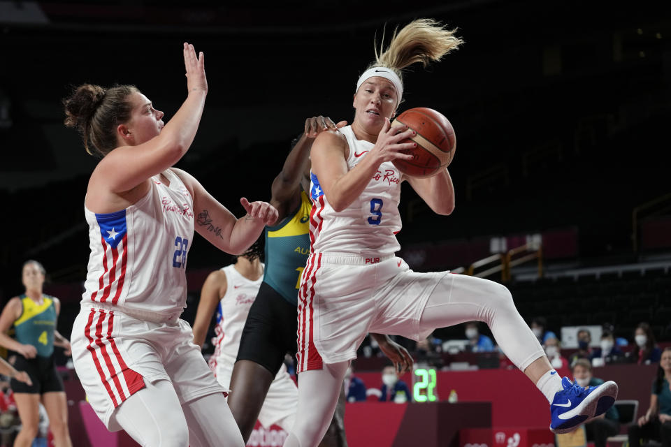 Puerto Rico's Ali Gibson (9) pulls down a rebound in front of Australia's Ezi Magbegor (13) during a women's basketball game at the 2020 Summer Olympics, Monday, Aug. 2, 2021, in Saitama, Japan. (AP Photo/Eric Gay)