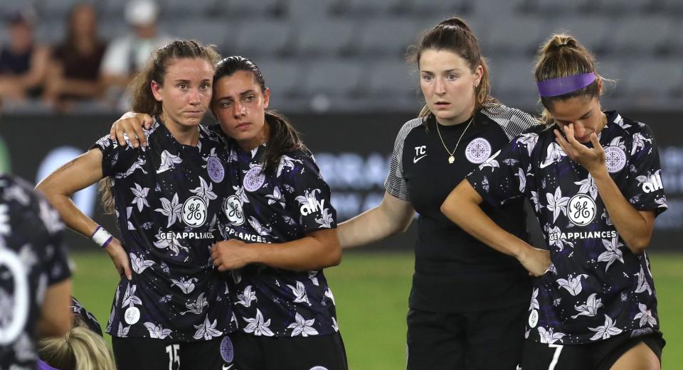 Racing Louisville FC’s Julia Lester< left, hugs Alex Chidac after they lost tp OL Reign in The Women’s Cup final.Aug. 20, 2022