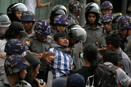 Myanmar police officers detain a student who takes part in a rally demanding peace at the war-torn Kachin State, in Yangon, Myanmar May 12, 2018. REUTERS/Stringer NO RESALES. NO ARCHIVES TPX IMAGES OF THE DAY