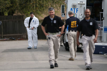 Law enforcement personnel investigate the surroundings of the home where Austin serial bomber Mark Anthony Conditt lived in Pflugerville, Texas, U.S., March 22, 2018. REUTERS/Loren Elliott