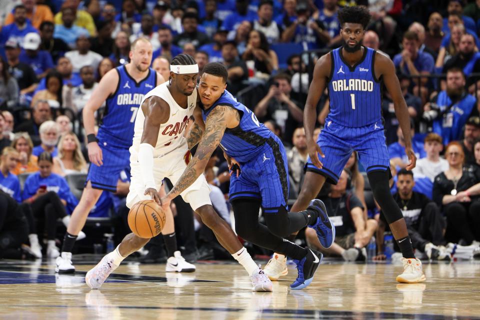 Apr 27, 2024; Orlando, Florida, USA; Orlando Magic guard Markelle Fultz (20) and Cleveland Cavaliers guard Caris LeVert (3) battle for the ball in the second quarter during game three of the first round for the 2024 NBA playoffs at Kia Center. Mandatory Credit: Nathan Ray Seebeck-USA TODAY Sports