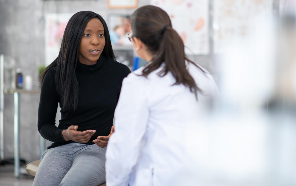 woman explaining her symptoms to a doctor